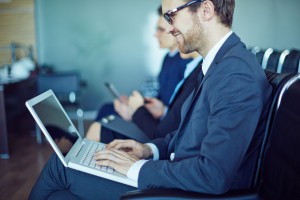 business man smiling at laptop