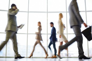 White collar workers going down office corridor at the end of working day