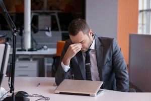 Frustrated business man on laptop