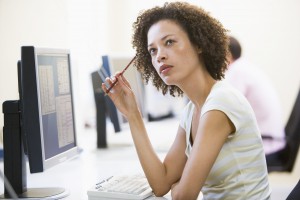 Woman in computer room thinking